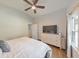 Comfortable bedroom includes a ceiling fan, large window, a TV on a white dresser at 222 Bishop Ne Dr, Marietta, GA 30060