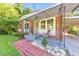 Inviting covered porch with brick accents, decorative gravel, and a welcome sign at 222 Bishop Ne Dr, Marietta, GA 30060