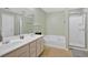 Bathroom with double sink vanity, soaking tub, and separate glass-enclosed shower at 2263 Nottley Dr # 2, Marietta, GA 30066