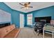 Vibrant room with blue walls, desk setup, and sofa bed at 2263 Nottley Dr # 2, Marietta, GA 30066