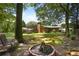 Expansive backyard featuring a fire pit, deck, and lush green lawn, ideal for relaxation at 476 Concord Se Ln, Smyrna, GA 30082