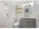 Updated bathroom with glass shower, patterned floor tiles, floating shelves, and a gray vanity at 476 Concord Se Ln, Smyrna, GA 30082