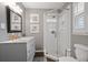 Updated bathroom with glass-enclosed shower, gray vanity, and blue-themed decor at 476 Concord Se Ln, Smyrna, GA 30082