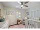Bright Bedroom featuring a ceiling fan, a crib, a comfortable chair and beautiful decor elements at 476 Concord Se Ln, Smyrna, GA 30082