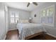 Inviting bedroom with hardwood floors, shuttered windows, and a light blue patterned bedspread at 476 Concord Se Ln, Smyrna, GA 30082