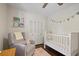 Bright Bedroom featuring a white crib, comfortable chair, and charming decor elements at 476 Concord Se Ln, Smyrna, GA 30082
