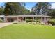 Charming brick home with a carport and a lush green lawn at 476 Concord Se Ln, Smyrna, GA 30082