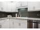 Close-up of white cabinets and stainless steel dishwasher in updated kitchen at 476 Concord Se Ln, Smyrna, GA 30082