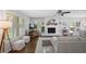 Inviting living room featuring a white brick fireplace and ample natural light at 476 Concord Se Ln, Smyrna, GA 30082