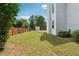 Well-maintained backyard with a wooden fence, lush grass, and views of the home's exterior at 6298 Gothards Ln, Douglasville, GA 30134