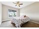 Comfortable bedroom featuring a ceiling fan, plush carpet, and bright natural light from a window at 6298 Gothards Ln, Douglasville, GA 30134