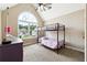 Bedroom features a bunk bed, a large window, carpeted floors, and a ceiling fan at 6298 Gothards Ln, Douglasville, GA 30134