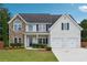 Charming two-story home with stone accents, manicured lawn, and a two-car garage at 6298 Gothards Ln, Douglasville, GA 30134