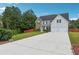 Inviting home exterior with a long driveway and a well-manicured front lawn at 6298 Gothards Ln, Douglasville, GA 30134