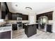 Modern kitchen featuring dark cabinets, stainless steel appliances, and a breakfast bar at 6298 Gothards Ln, Douglasville, GA 30134
