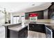 Well-lit kitchen with granite countertops, stainless steel appliances, and dark cabinets at 6298 Gothards Ln, Douglasville, GA 30134