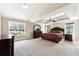 Spacious main bedroom features tray ceilings, ceiling fan, large windows, and plush carpet at 6298 Gothards Ln, Douglasville, GA 30134