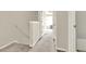 Upstairs hallway with neutral walls and carpeting, showing doors to bedrooms and bath at 88 Timber Ridge Dr, Cartersville, GA 30121