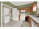Well-equipped kitchen with modern appliances, cabinetry, and laundry hookups at 88 Timber Ridge Dr, Cartersville, GA 30121