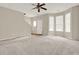 Spacious living room featuring neutral walls, large front windows, and stairs to the second floor at 88 Timber Ridge Dr, Cartersville, GA 30121