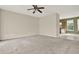 Spacious living room featuring neutral walls, a ceiling fan, and an open doorway to the kitchen at 88 Timber Ridge Dr, Cartersville, GA 30121