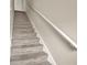 Carpeted staircase with a white handrail leading to the upper level of the house at 88 Timber Ridge Dr, Cartersville, GA 30121