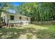 A spacious, fenced backyard with lush greenery surrounds a cozy home at 114 Howell Sw Dr, Atlanta, GA 30331