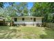 The home features a large fenced backyard surrounded by mature trees at 114 Howell Sw Dr, Atlanta, GA 30331