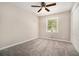 Neutral bedroom with plush carpeting, a ceiling fan, and bright windows at 114 Howell Sw Dr, Atlanta, GA 30331