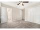 Bright bedroom with neutral carpet, ceiling fan, and white closet doors at 114 Howell Sw Dr, Atlanta, GA 30331