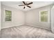 Comfortable bedroom with plush carpeting, bright windows, and a ceiling fan at 114 Howell Sw Dr, Atlanta, GA 30331