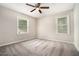 Bright bedroom with soft carpeting, a ceiling fan, and a view from the windows at 114 Howell Sw Dr, Atlanta, GA 30331