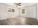 Cozy bedroom with modern gray wood-look flooring, natural light, and a ceiling fan at 114 Howell Sw Dr, Atlanta, GA 30331