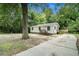 Quaint home with inviting porch, set among mature trees and landscaping at 114 Howell Sw Dr, Atlanta, GA 30331