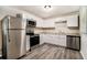 Modern kitchen featuring stainless steel appliances, white cabinets, and durable countertops at 114 Howell Sw Dr, Atlanta, GA 30331