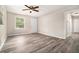 Inviting living room showcasing stylish gray wood-look flooring, a ceiling fan, and a bright, airy atmosphere at 114 Howell Sw Dr, Atlanta, GA 30331