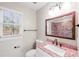 Bathroom with granite countertop, modern faucet and a large framed mirror at 1403 W Prospect Dr, Lawrenceville, GA 30043
