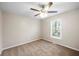 Clean bedroom featuring neutral paint and carpet, ceiling fan and a window view at 1403 W Prospect Dr, Lawrenceville, GA 30043