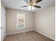 Bedroom with ceiling fan, neutral paint and carpet, and a view to the backyard at 1403 W Prospect Dr, Lawrenceville, GA 30043