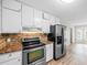 Updated kitchen boasts stainless steel appliances, granite countertops, and a tile backsplash at 1403 W Prospect Dr, Lawrenceville, GA 30043