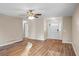 Bright living room with new wood floors, a ceiling fan, and neutral paint at 1403 W Prospect Dr, Lawrenceville, GA 30043