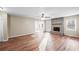 Spacious living room featuring an open layout, wood floors, and a stone fireplace at 1403 W Prospect Dr, Lawrenceville, GA 30043