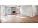 Open-concept living room with a stone fireplace and an exit to the backyard at 1403 W Prospect Dr, Lawrenceville, GA 30043
