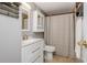 Well-lit bathroom features a vanity, a tiled floor, and shower with curtain at 2479 Peachtree Ne Rd # 201, Atlanta, GA 30305