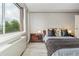 Bright bedroom featuring a large window with an exterior view, neutral walls, and modern decor at 2479 Peachtree Ne Rd # 201, Atlanta, GA 30305