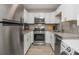 Modern kitchen with stainless steel appliances, granite countertops, and white cabinets at 2479 Peachtree Ne Rd # 201, Atlanta, GA 30305