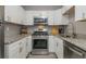 Modern kitchen features stainless steel appliances, white cabinetry, granite countertops, and ample natural light at 2479 Peachtree Ne Rd # 201, Atlanta, GA 30305
