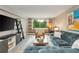 Inviting living room showcasing a comfortable blue sofa, modern shelving, and a bright window with a natural view at 2479 Peachtree Ne Rd # 201, Atlanta, GA 30305