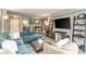 Spacious living room with a comfortable blue sofa, modern entertainment unit, and an open-concept dining area at 2479 Peachtree Ne Rd # 201, Atlanta, GA 30305