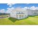 Beautiful backyard featuring a large lawn, patio, and a two-story home at 2929 Champions Way, Loganville, GA 30052